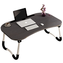 Laptops with foldable lazy students on the table and bed
